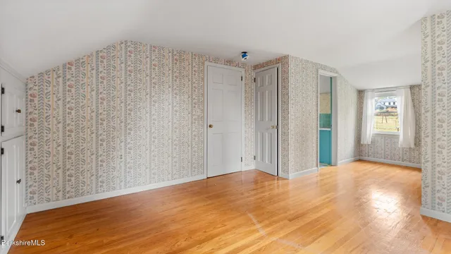 a view of a room with wooden floor