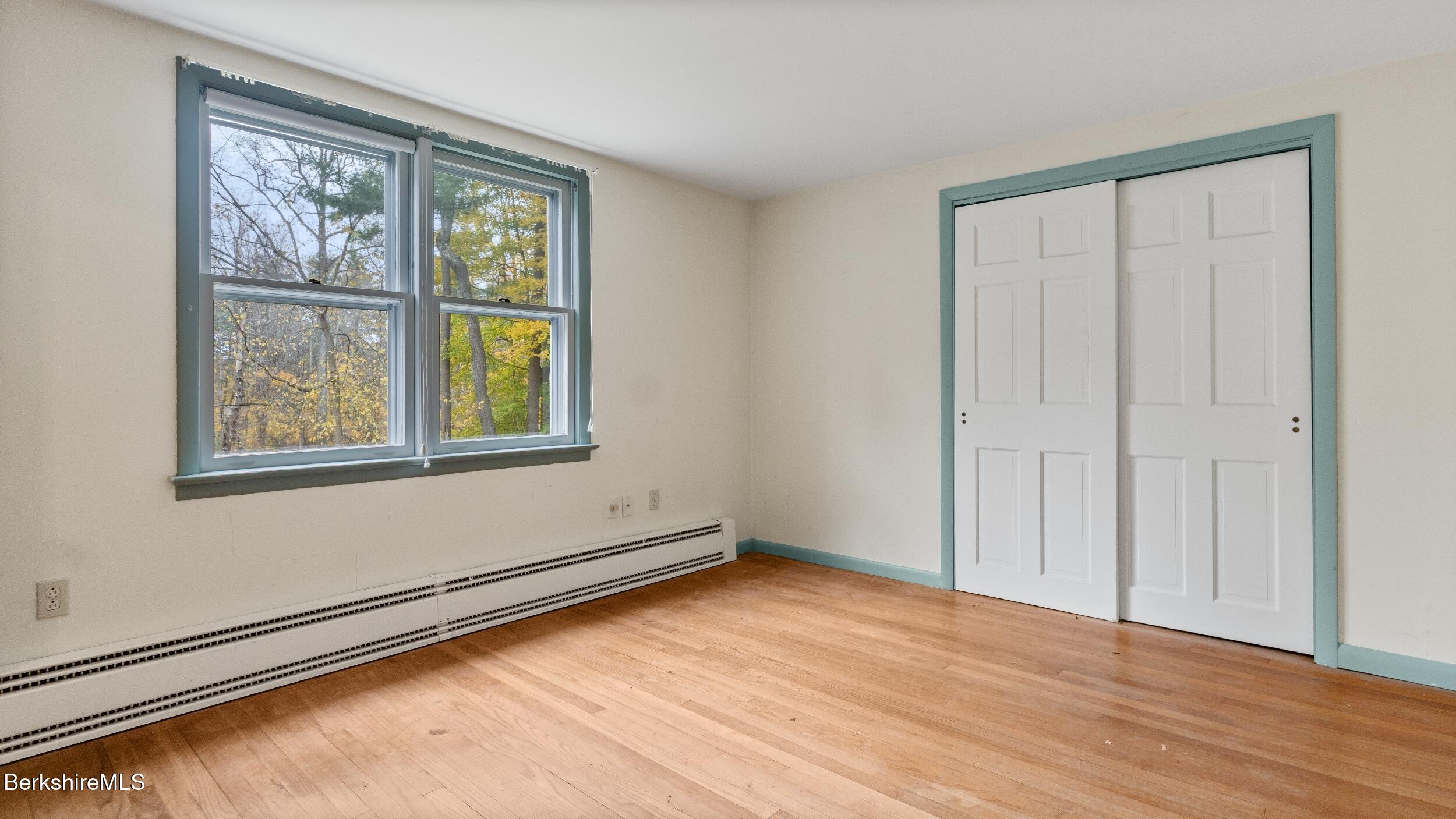 3 Pleasant View Drive Great Barrington, MA 01230 - Photo 21 of 28 an empty room with wooden floor and windows