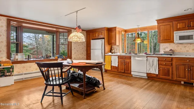 a view of room with window and wooden floor