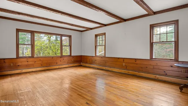 a view of room with wooden floor and fan