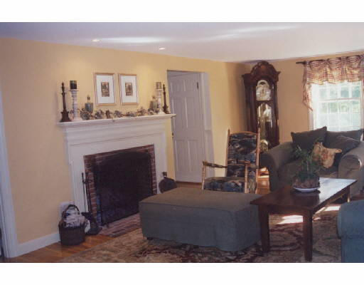 383 Lowell Road Concord, MA 01742 - Photo 2 of 4 a living room with furniture and a fireplace