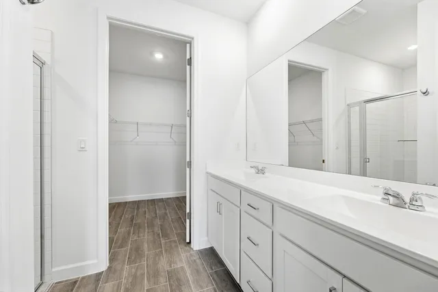 a spacious bathroom with a double vanity sink and mirror