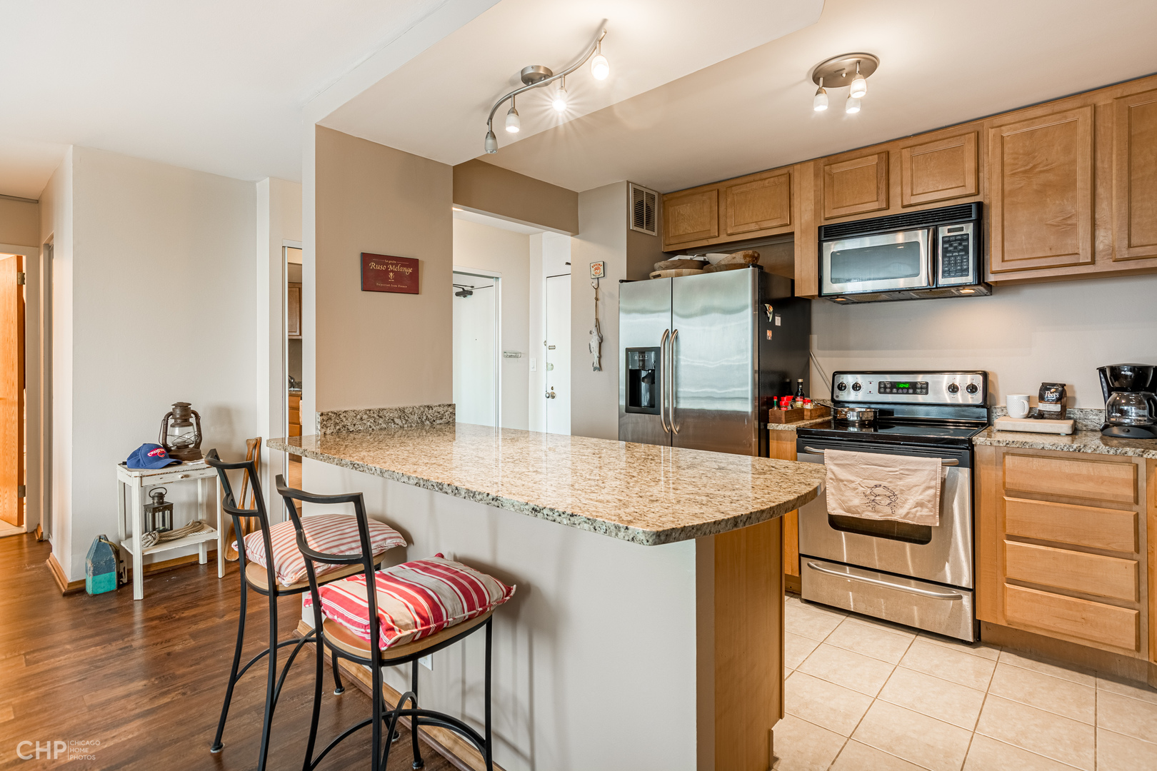 5455 North Sheridan Road, Unit 710 Chicago, IL 60640 - Photo 2 of 11 a kitchen with stainless steel appliances granite countertop a stove refrigerator sink and cabinets