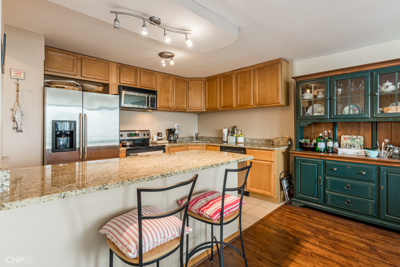 5455 North Sheridan Road, Unit 710 Chicago, IL 60640 - Photo 3 of 11 a kitchen with granite countertop a sink cabinets and window