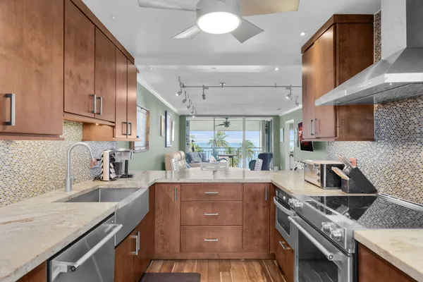 a kitchen with a sink stove and cabinets