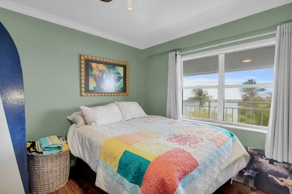 a bedroom with a bed and a large window