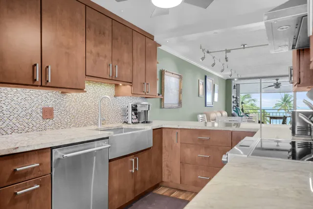 a kitchen with stainless steel appliances granite countertop a sink stove and cabinets