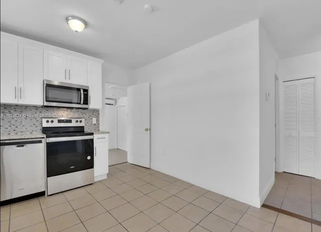 a kitchen with a sink and a stove top oven