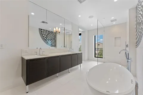 a large bathroom with a double vanity sink a large mirror and shower