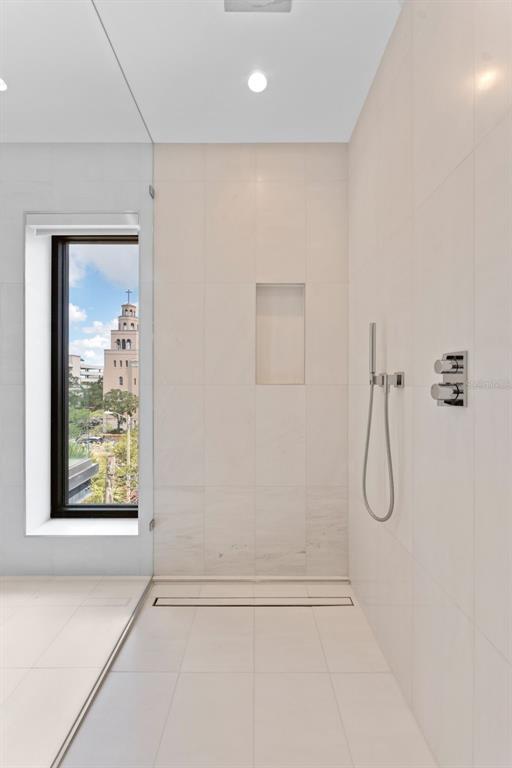 465 Central Avenue, Unit 301 St. Petersburg, FL 33701 - Photo 18 of 47 a bathroom with a glass shower door