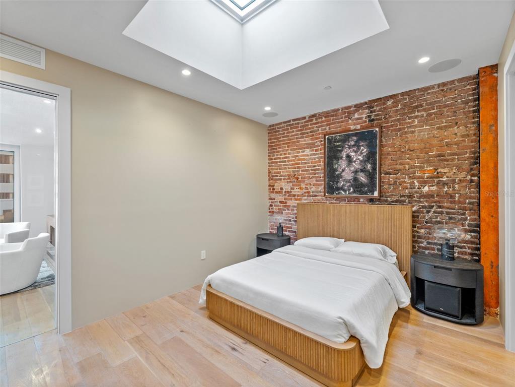 465 Central Avenue, Unit 301 St. Petersburg, FL 33701 - Photo 21 of 47 a bedroom with a bed and a wall painting