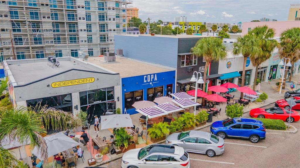 465 Central Avenue, Unit 301 St. Petersburg, FL 33701 - Photo 47 of 47 a front view of building with outdoor seating and a potted plant
