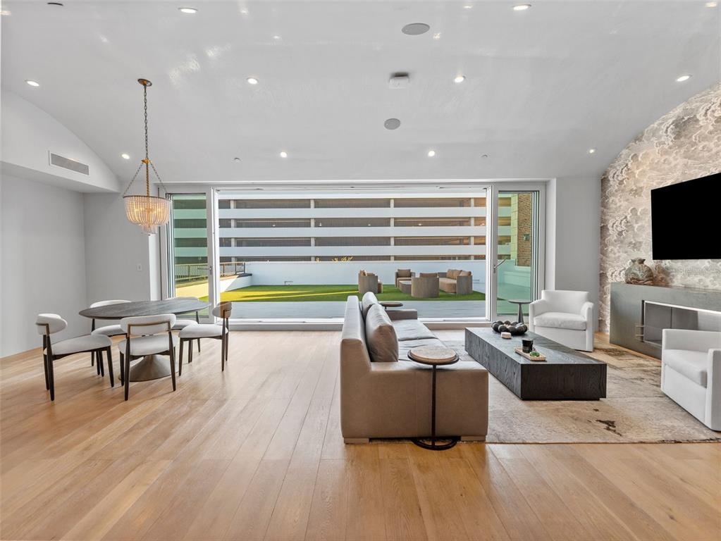 465 Central Avenue, Unit 301 St. Petersburg, FL 33701 - Photo 6 of 47 a living room with fireplace furniture and a flat screen tv