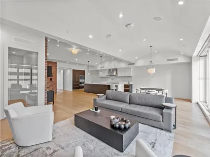 a living room with furniture and kitchen view
