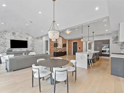 a large kitchen with a table and chairs
