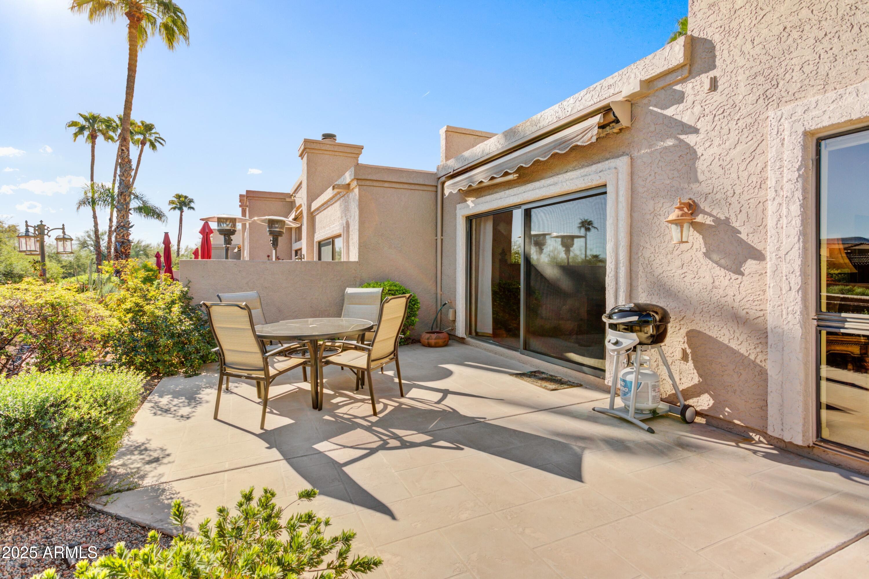 25609 Forest Road, Unit 7 Rio Verde, AZ 85263 - Photo 12 of 21 a view of a patio with table and chairs and potted plants