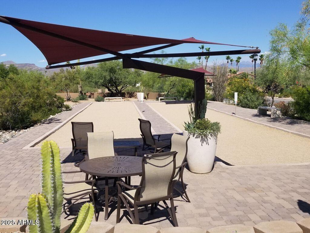 25609 Forest Road, Unit 7 Rio Verde, AZ 85263 - Photo 17 of 21 a roof deck with table and chairs under an umbrella