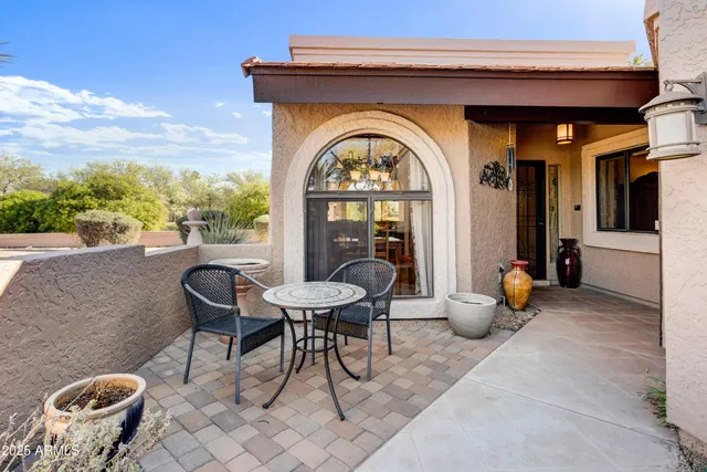a view of a chairs and table in a patio