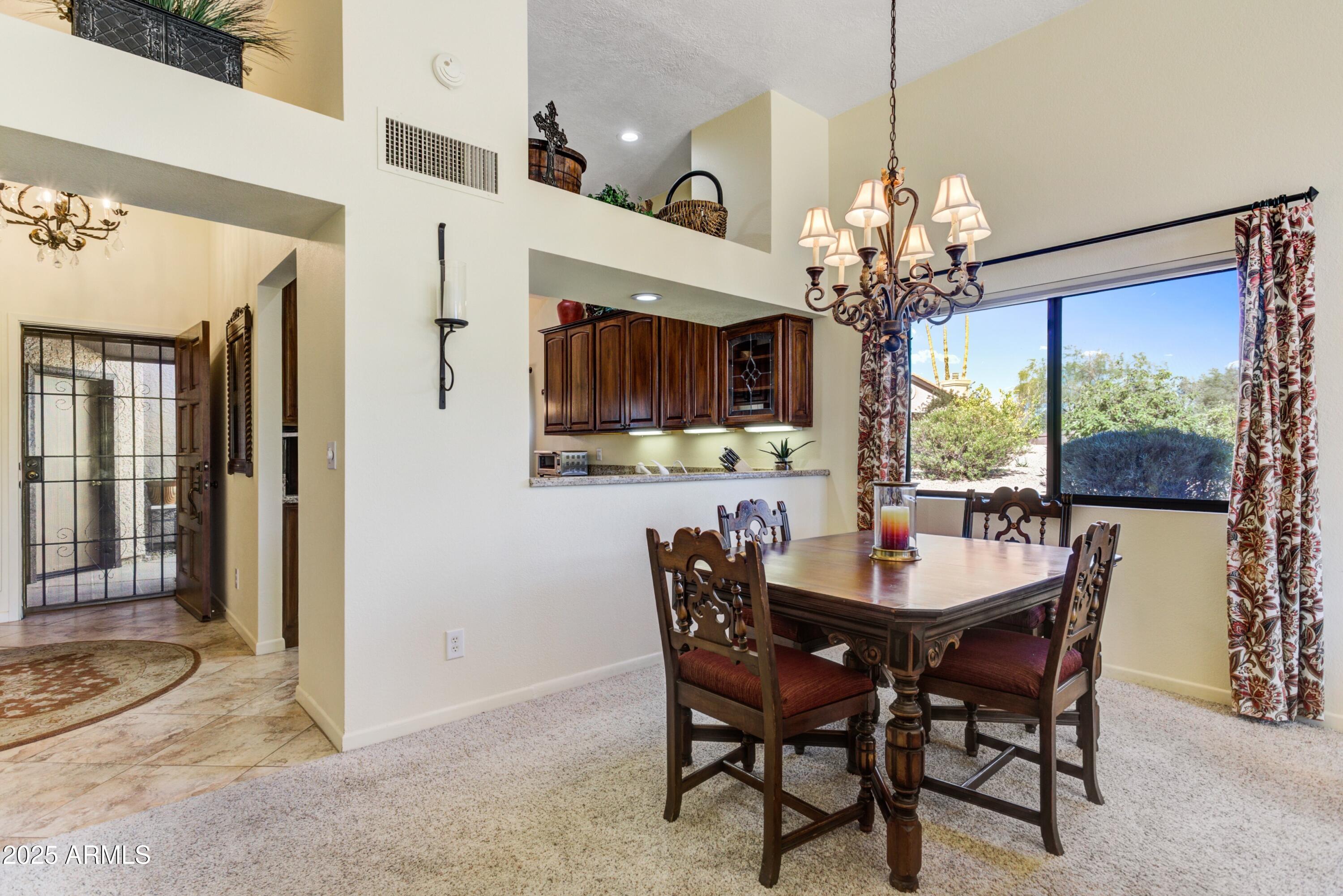 25609 Forest Road, Unit 7 Rio Verde, AZ 85263 - Photo 3 of 21 a view of a dining room with furniture window and wooden floor