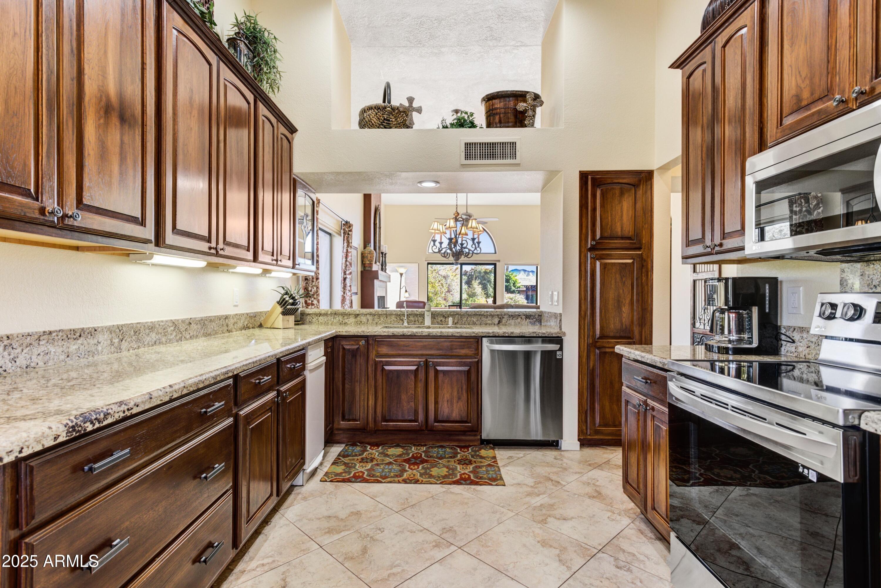 25609 Forest Road, Unit 7 Rio Verde, AZ 85263 - Photo 7 of 21 a kitchen with stainless steel appliances granite countertop a stove and a sink