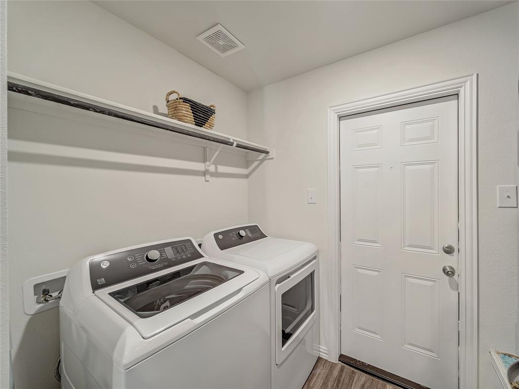 921 West 9th Street Bonham, TX 75418 - Photo 19 of 22 Laundry room with washer and dryer and light wood-style flooring
