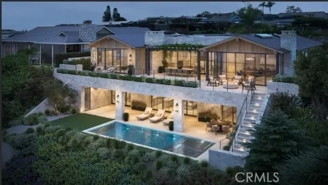 an aerial view of a house with swimming pool garden and patio