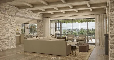 a living room with furniture and a floor to ceiling window