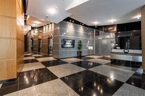 3338 Peachtree Road Northeast, Unit 809 Atlanta, GA 30326 - Photo 17 of 23 a lobby with gym equipment and glass door