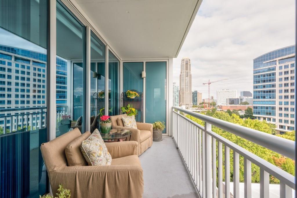3338 Peachtree Road Northeast, Unit 809 Atlanta, GA 30326 - Photo 2 of 23 a balcony with furniture and a potted plant