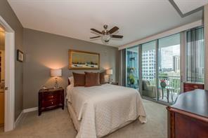 3338 Peachtree Road Northeast, Unit 809 Atlanta, GA 30326 - Photo 4 of 23 a bedroom with a balcony a bed and a chandelier