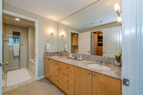 3338 Peachtree Road Northeast, Unit 809 Atlanta, GA 30326 - Photo 6 of 23 a bathroom with a granite countertop double vanity sink and a mirror