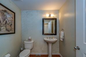 3338 Peachtree Road Northeast, Unit 809 Atlanta, GA 30326 - Photo 7 of 23 a bathroom with a toilet sink and mirror