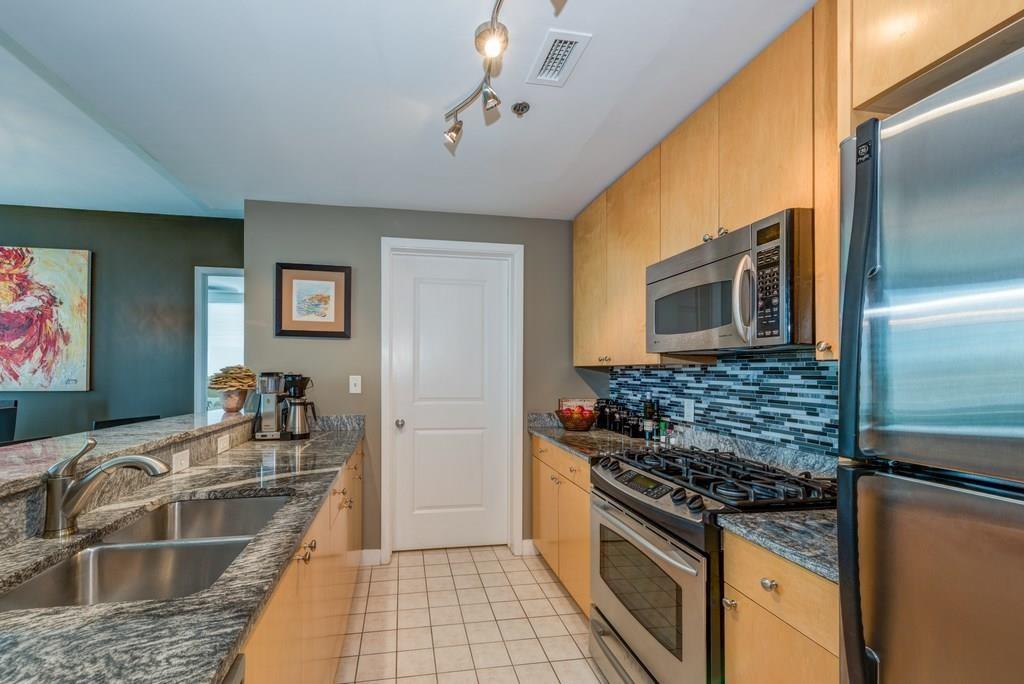 3338 Peachtree Road Northeast, Unit 809 Atlanta, GA 30326 - Photo 9 of 23 a kitchen with granite countertop a sink stainless steel appliances a counter space and cabinets
