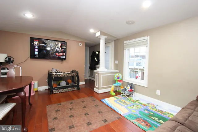 a bedroom with furniture and a flat screen tv