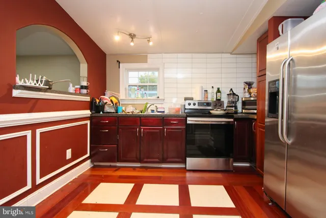 a kitchen with a sink window and cabinets
