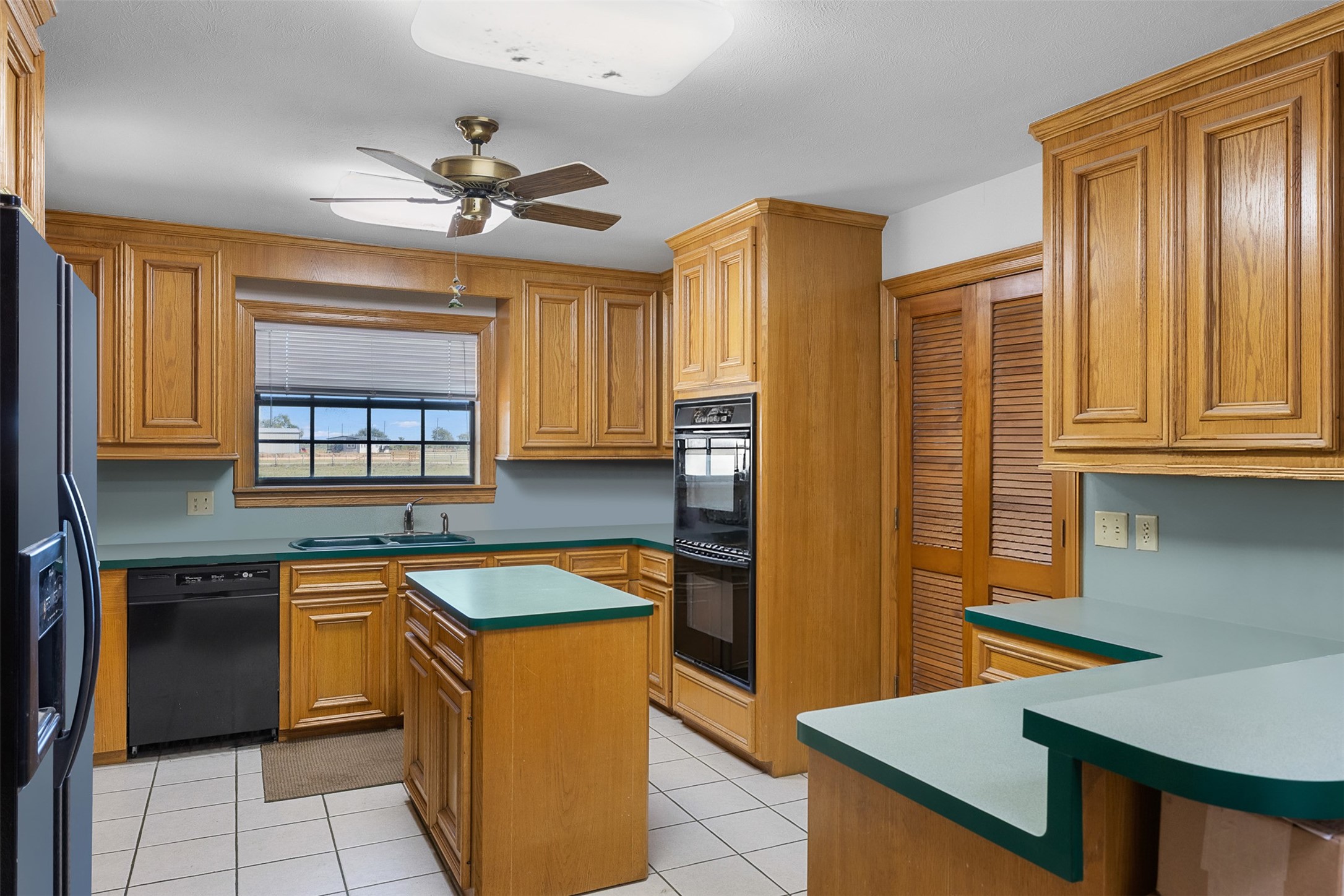 4231 Johnston Road Wallis, TX 77485 - Photo 11 of 43 a kitchen with stainless steel appliances granite countertop a sink cabinets and wooden floor