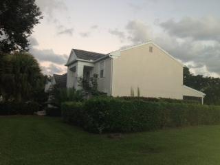 3870 Sabal Lakes Road Delray Beach, FL 33445 - Photo 5 of 17 a view of a white house next to a yard