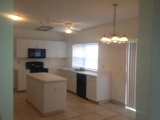 3870 Sabal Lakes Road Delray Beach, FL 33445 - Photo 10 of 17 a kitchen that has a sink and a stove top oven