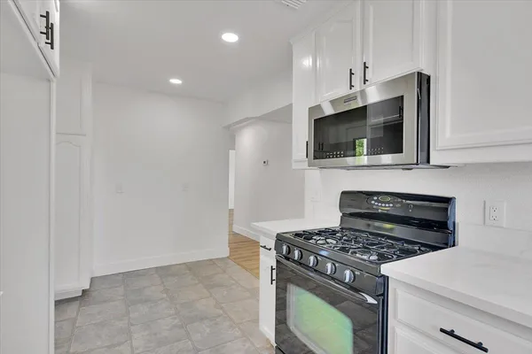 a kitchen with a stove and a microwave
