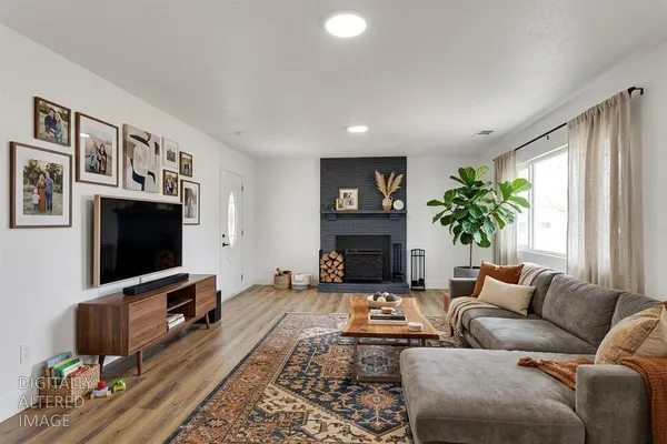 a living room with furniture a flat screen tv and a fireplace