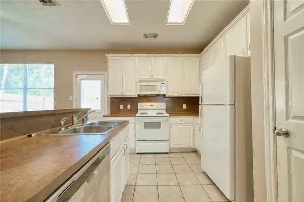 a kitchen with a sink stove and refrigerator