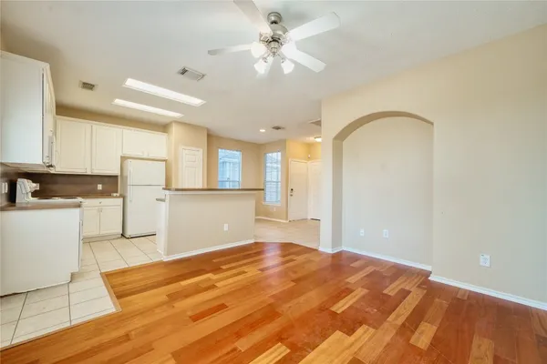 a bedroom with a bed cabinets and a window