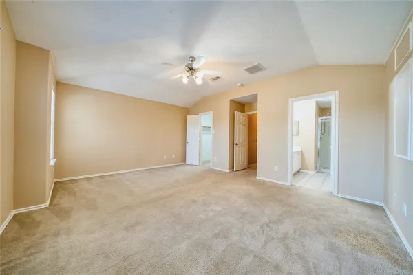 a view of an empty room with a ceiling fan