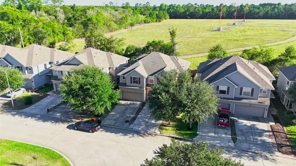 an aerial view of a house with a garden and lake view