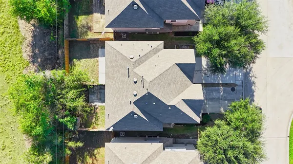 an aerial view of a house with a yard and balcony
