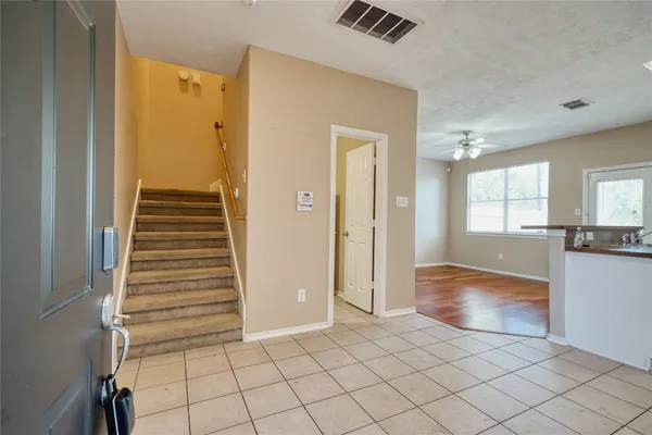 a view of kitchen and hallway with windows