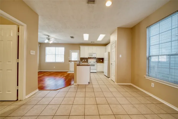 a view of kitchen and dining area with chandelier