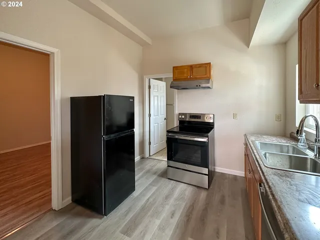 a kitchen with a refrigerator and a sink