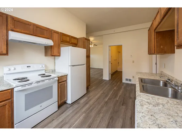 a kitchen with a sink stove and refrigerator