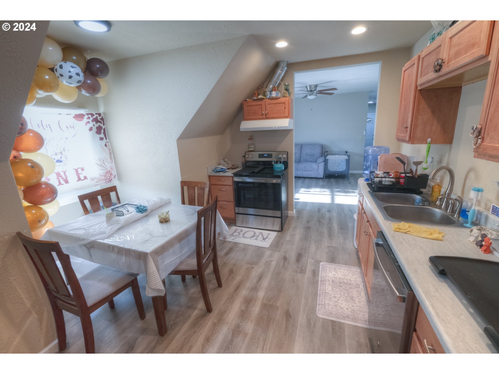 415 Southwest 7th Street Pendleton, OR 97801 - Photo 10 of 40 a kitchen with a wooden floor and chairs